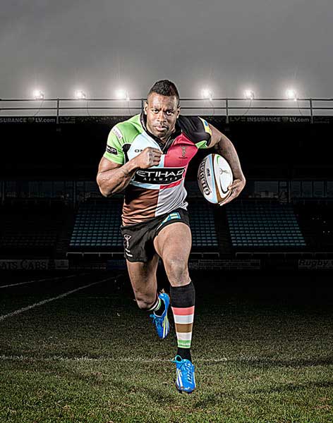 Ugo Monye, England Rugby Player for Men's Health. Although I've made subtle alterations to tone and sharpness in Photoshop, the main “cheat” are the lights in the background. They weren't lit on the day, and close inspection will show that they're all pretty identical and aren't casting any light on the ground, (or on Ugo)!