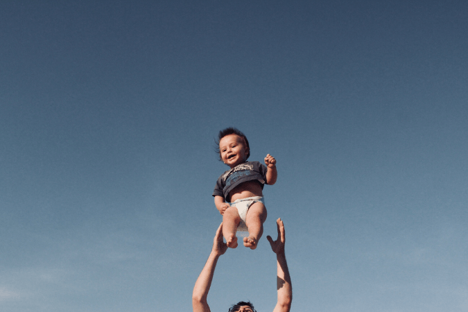 Photo of baby being tossed in the air to illustrate using burst mode.