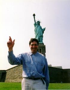 If the subject is Joe at the Statue, we want them both to be big, like this. How can we achieve this? By having Joe come closer to the camera. Now both Joe and the Statue appear big in the frame. © Chuck DeLaney, NYIP Dean