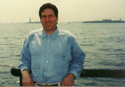 Here's a photo taken at the water's edge in Battery Park. The Statue is just a speck over his shoulder, so this is really just a picture of Joe. © Chuck DeLaney, NYIP Dean