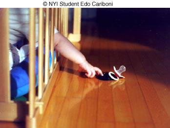 Baby reaching pacififer by NYIP Student Edo Cariboni