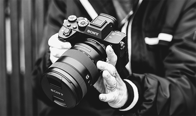 Person holding digital camera with wide-angle lens 