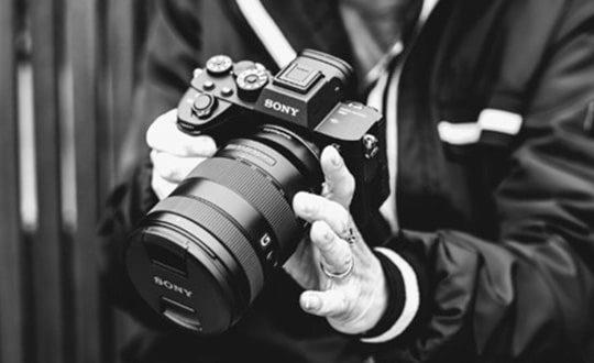 Person holding digital camera with wide-angle lens 